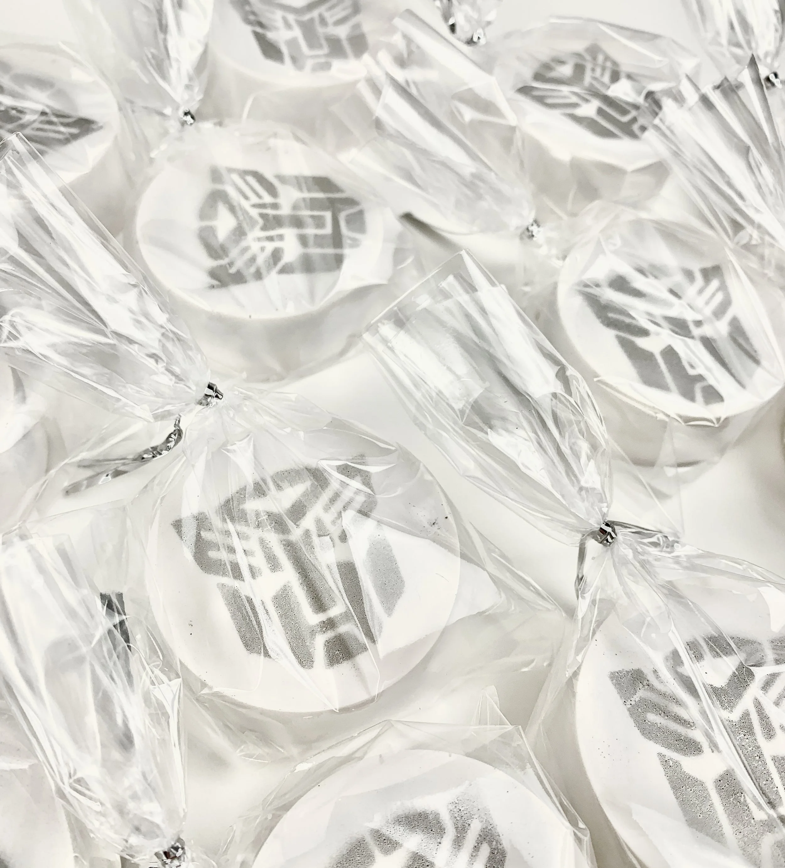 Close up image of Cake Pucks (cake pop with a filling and a crunch) with the Autobot logo on them, 